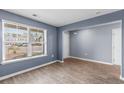 Cozy room with neutral floors and blue walls features a bright window offering neighborhood views and natural lighting at 224 Pine Forest Dr., Conway, SC 29526