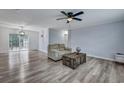 Inviting living room featuring sleek flooring, calming wall colors, and a stylish ceiling fan at 308 Stone Throw Dr., Murrells Inlet, SC 29576