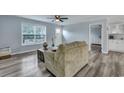 Inviting living room with a rear view of the loveseat, a neutral color palette, and wood-look flooring at 308 Stone Throw Dr., Murrells Inlet, SC 29576