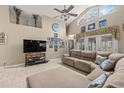 Bright living room featuring vaulted ceilings, tile floors, a large sectional sofa, and entertainment center at 3103 Robyn Ct., Little River, SC 29566