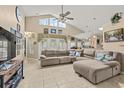 Spacious living room with a large sectional, tile floors, vaulted ceiling, and ample natural light, creating a cozy atmosphere at 3103 Robyn Ct., Little River, SC 29566