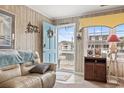 Cozy living room with wood paneling, comfortable seating, and a view of the front porch at 315 60Th Ave. N, North Myrtle Beach, SC 29582