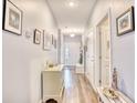 Inviting foyer with light gray walls and wood flooring, decorated with artwork and furnishings at 321 Rycola Circle, Surfside Beach, SC 29575