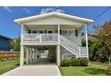 Charming beach house featuring elevated design, front porch, and covered parking at 342 Dogwood Dr. S, Murrells Inlet, SC 29576