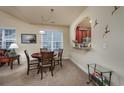 Cozy dining area featuring a wooden table set for four, with view into an open kitchen and stylish decor at 3507 Club Course Dr., North Myrtle Beach, SC 29582