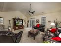 Spacious living room with neutral tones, plush seating, ceiling fan, and large windows offering ample natural light at 3507 Club Course Dr., North Myrtle Beach, SC 29582