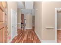 Welcoming foyer features gleaming hardwood floors, neutral paint, and seamless transition to living spaces at 401 Oak Crest Circle, Longs, SC 29568