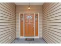 Inviting front entrance showcasing a stylish door with sidelights and elegant exterior lighting at 401 Oak Crest Circle, Longs, SC 29568