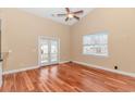 Bright living room enhanced by vaulted ceilings, wood floors, ceiling fan and access to the outdoors at 401 Oak Crest Circle, Longs, SC 29568