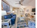 Cozy living room features comfortable blue sofa, ceiling fan, and nautical decor at 410 Melrose Pl. # 304, Myrtle Beach, SC 29572