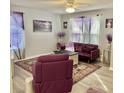 Bright living room features a purple theme, plush furniture, and light gray wood floors at 415 28Th Ave. N # 4-A, Myrtle Beach, SC 29577