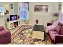 Cozy living room features a modern fireplace, purple-themed decor, and plush seating at 415 28Th Ave. N # 4-A, Myrtle Beach, SC 29577