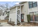 Charming condo entrance with white wood lattice and stairs leading to front door; inviting curb appeal and easy access at 4502 Little River Inn Ln. # 2507, Little River, SC 29566