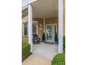 Inviting covered front porch with seating and potted plants at 4515 Lighthouse Dr. # 25B, Little River, SC 29566