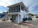 Angle view of beach home featuring screened porches, vinyl siding, and exterior features at 4601 Lewis St., North Myrtle Beach, SC 29582