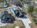 Aerial view of a modern farmhouse featuring a backyard pool, patio, and manicured landscaping at 4860 Mill Pond Rd., Myrtle Beach, SC 29588