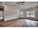 Open-concept living room with hardwood floors, large window, and a white front door at 4975 Dupont Rd., Conway, SC 29526