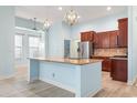 Open kitchen with a large island, stainless steel appliances, granite countertops, and wooden cabinetry at 5230 Piemonte Ln., Myrtle Beach, SC 29579