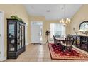 Bright dining room with a chandelier, black cabinet, and a large front window at 537 Sand Ridge Rd., Conway, SC 29526