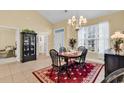 Bright dining room with tile floors, a wood table, and front door view at 537 Sand Ridge Rd., Conway, SC 29526