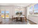 Elegant dining area with a modern chandelier, large windows, and views of the water at 538 Haven View Way, Murrells Inlet, SC 29576