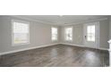 Spacious living room featuring gray wood-look tile flooring and plenty of natural light at 546 Haven View Way, Murrells Inlet, SC 29576