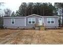 Charming single-story home with gray siding, white trim, and a neatly landscaped front yard at 5810 Hwy 9, Nichols, SC 29581