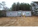 Charming single-story home with gray siding, white trim, and a neatly landscaped front yard at 5810 Hwy 9, Nichols, SC 29581