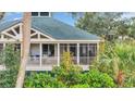 Relaxing screened porch with comfortable seating, perfect for enjoying the outdoors at 65 Lakeside Dr. # 65A, Pawleys Island, SC 29585