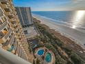 High-angle view of a condo building, with a glimpse of the beach and ocean at 8500 Margate Circle # 1604, Myrtle Beach, SC 29572