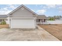 Single-Gathering home with a spacious two-car garage and a quaint, covered front porch at 9545 Sullivan Dr., Murrells Inlet, SC 29576