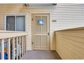 Welcoming condo entrance featuring a 'Welcome' sign and a cozy, private balcony at 9620 Shore Dr. # C101, Myrtle Beach, SC 29572