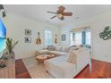 Bright living room featuring a large sectional, hardwood floors, and unique decor at 10 Orchard Ave., Murrells Inlet, SC 29576