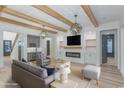 Inviting living room featuring exposed beams, modern lighting, a fireplace, and seamless integration with the home's design at 1054 East Isle Of Palms Ave., Myrtle Beach, SC 29579