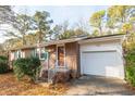 Inviting brick home with a single-car garage and a neatly landscaped front entrance at 1105 Scott Dr., Myrtle Beach, SC 29577