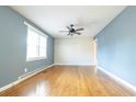 Bright living room with hardwood floors, a ceiling fan, and a modern accent wall at 1105 Scott Dr., Myrtle Beach, SC 29577