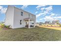 View of the home's rear facade with a covered patio and ample green space at 124 Shucking St., Myrtle Beach, SC 29588