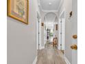 Hallway with hard flooring, neutral paint, and an archway with multiple doors along the sides at 131 Waypoint Ridge Ave. # Q-14, Little River, SC 29566