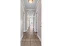 Bright hallway with wood-look flooring, white doors, and views into the unit, creating a welcoming entrance at 131 Waypoint Ridge Ave. # Q-14, Little River, SC 29566