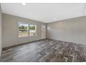 Inviting living room with wood-look floors, bright windows, and neutral wall colors at 1310 Rabbit Ln., Conway, SC 29526