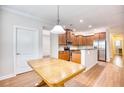 Open kitchen featuring wood cabinets, stainless steel appliances, and an eat-in breakfast bar at 1537 Beaumont Way, Myrtle Beach, SC 29577