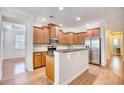 Well-lit kitchen featuring wood cabinets, stainless steel appliances, and a stylish breakfast bar at 1537 Beaumont Way, Myrtle Beach, SC 29577