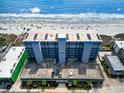 An aerial view of the building and parking deck close to the sandy beach at 1709 S Ocean Blvd. # 411, North Myrtle Beach, SC 29582