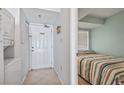 A small bedroom with a single bed featuring neutral colored walls and a door at 1709 S Ocean Blvd. # 411, North Myrtle Beach, SC 29582