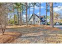 Charming home with a blue door framed by tall trees and a beautifully landscaped front yard at 1800 Glenns Bay Rd., Surfside Beach, SC 29575