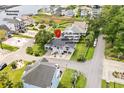 Aerial view of a gray beach house near the Intracoastal Waterway with lush surroundings at 202 Old Harbour Ct., Little River, SC 29566