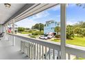 View from the balcony overlooking a street with houses, palm trees and parked cars at 202 Old Harbour Ct., Little River, SC 29566