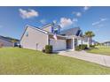 A well-maintained one-story home with an attached two-car garage and lush green lawn at 2051 Lindrick Ct., Calabash, NC 28467