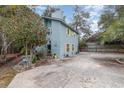 Charming two-story home featuring light blue siding, yellow shutters, and a paved driveway at 2270 Vereen Circle, Little River, SC 29566