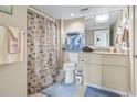 Well-lit bathroom with a toilet, vanity, a mirror and tub with shower and nautical themed shower curtain at 2301 S Ocean Blvd. # 1401, North Myrtle Beach, SC 29582